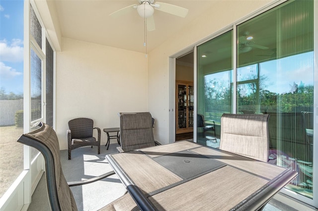 sunroom featuring ceiling fan