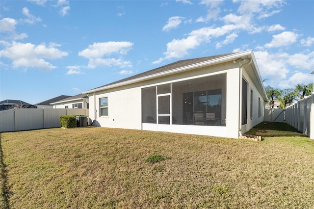 back of house with a lawn, cooling unit, and a sunroom