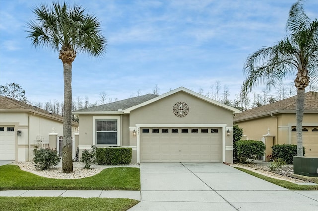 single story home featuring a garage and cooling unit