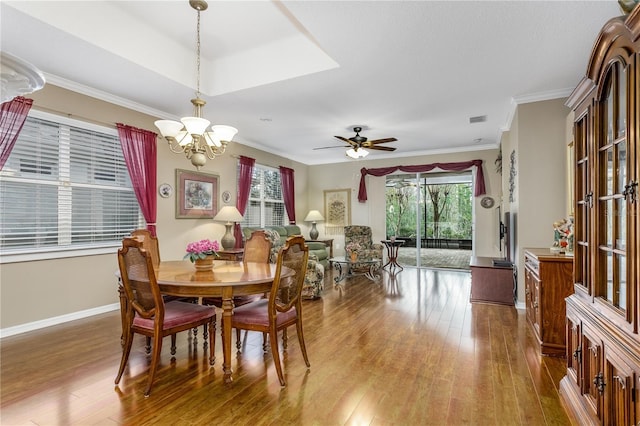 dining space featuring ceiling fan with notable chandelier, hardwood / wood-style floors, and ornamental molding