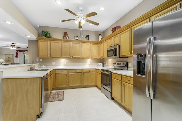 kitchen featuring ceiling fan, sink, kitchen peninsula, and stainless steel appliances