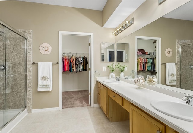 bathroom featuring an enclosed shower, vanity, and tile patterned flooring