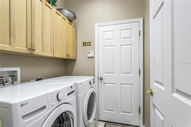 laundry area featuring washer and dryer and cabinets