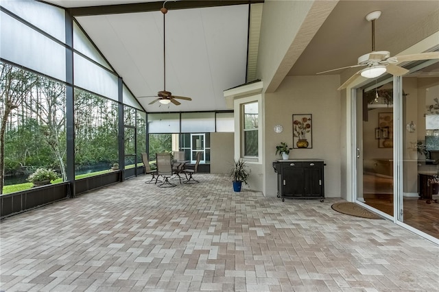 unfurnished sunroom featuring vaulted ceiling