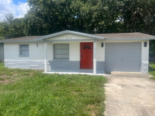 single story home featuring a front yard and a garage