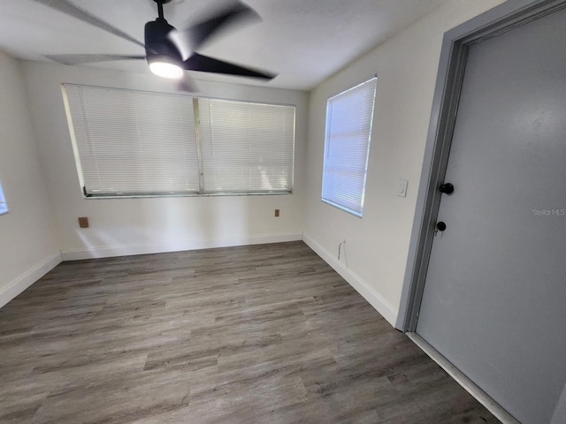 spare room with wood-type flooring and ceiling fan