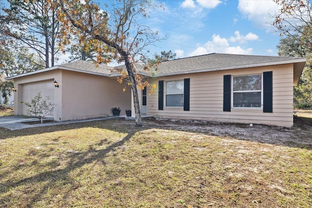 ranch-style house featuring a garage and a front lawn