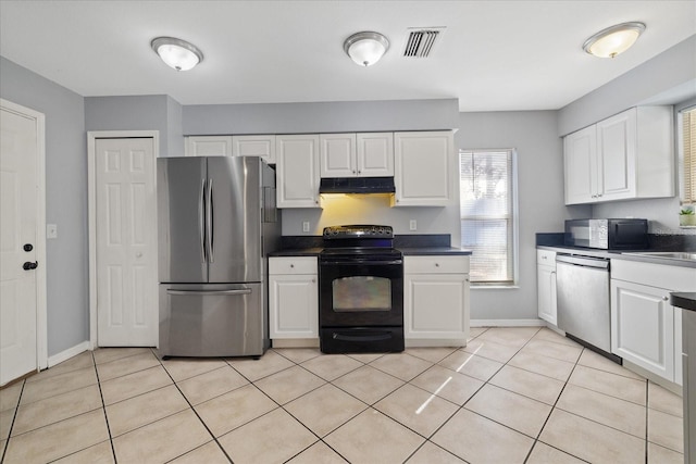 kitchen with light tile patterned floors, stainless steel appliances, and white cabinetry