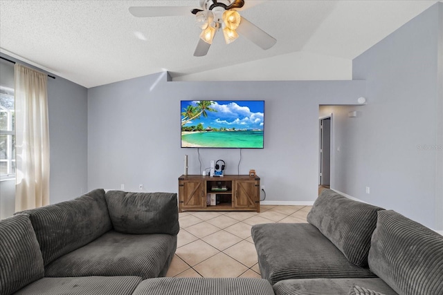 living room with a textured ceiling, ceiling fan, light tile patterned floors, and lofted ceiling