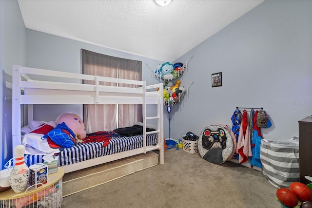 bedroom featuring a textured ceiling, carpet, and lofted ceiling