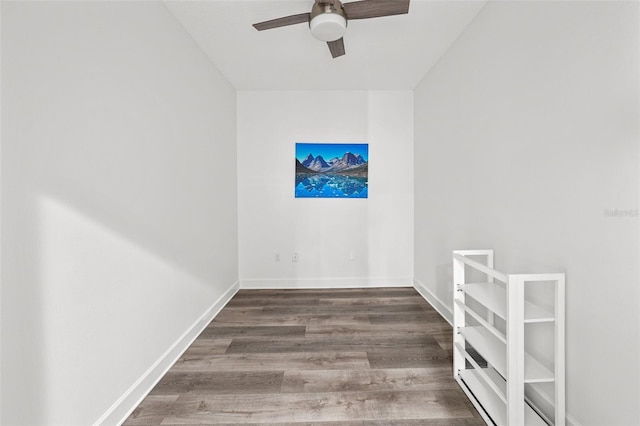 unfurnished room with ceiling fan and dark wood-type flooring