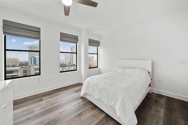 bedroom with ceiling fan and hardwood / wood-style flooring