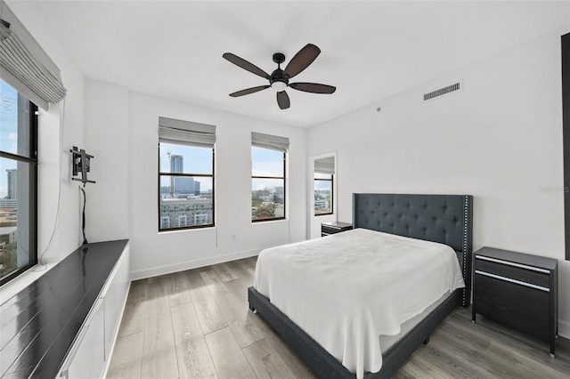 bedroom with ceiling fan and hardwood / wood-style floors