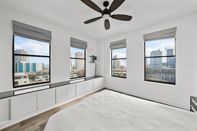 bedroom with ceiling fan and hardwood / wood-style floors