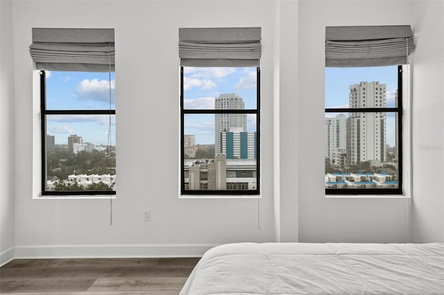 bedroom featuring hardwood / wood-style flooring and multiple windows