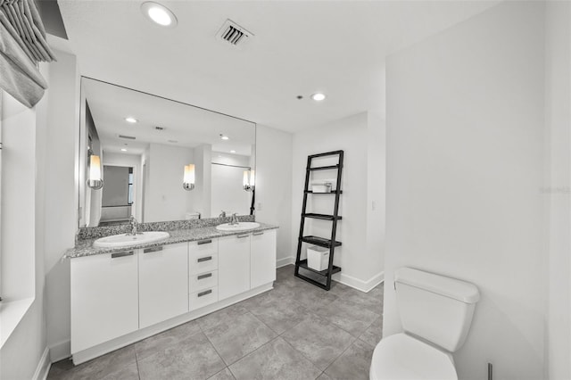 bathroom featuring toilet and vanity