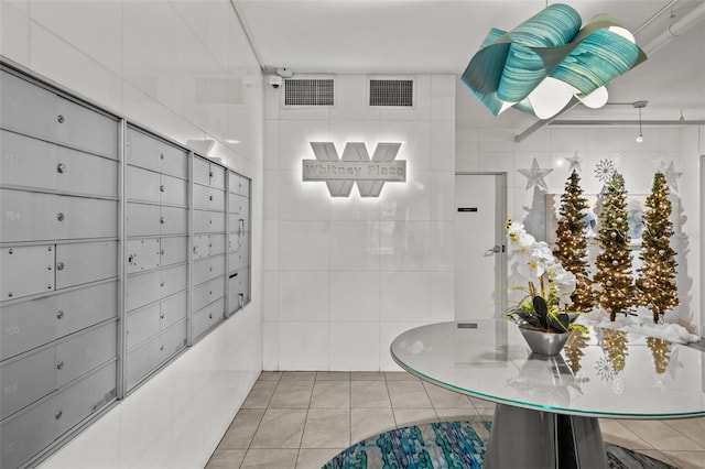 bathroom with a mail area, tile walls, and tile patterned floors