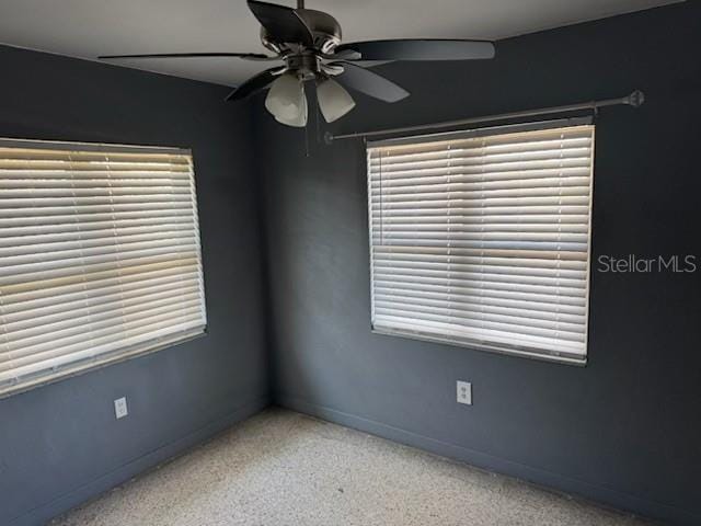 spare room with plenty of natural light and ceiling fan