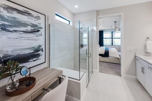 bathroom featuring walk in shower, vanity, and a wealth of natural light