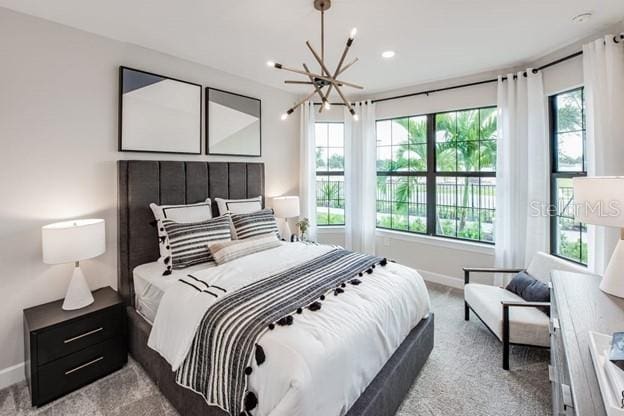 carpeted bedroom with a notable chandelier