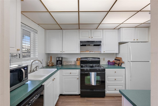 kitchen featuring black appliances, ventilation hood, sink, white cabinets, and tasteful backsplash