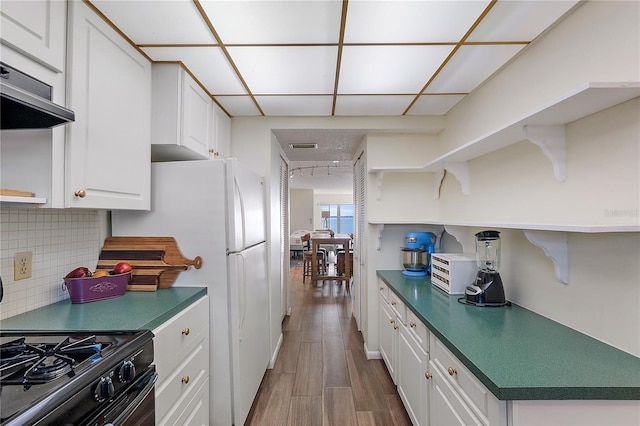 kitchen featuring open shelves, backsplash, dark countertops, white cabinetry, and exhaust hood