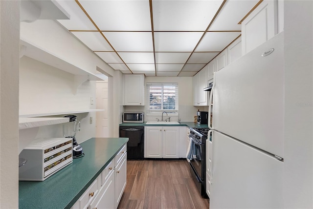 kitchen with tasteful backsplash, dark wood finished floors, white cabinets, black appliances, and open shelves