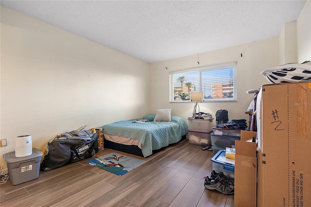 bedroom featuring wood-type flooring and a textured ceiling