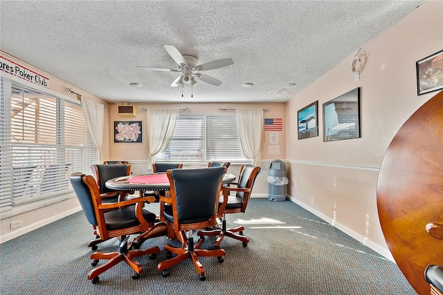 carpeted dining space with ceiling fan and a textured ceiling