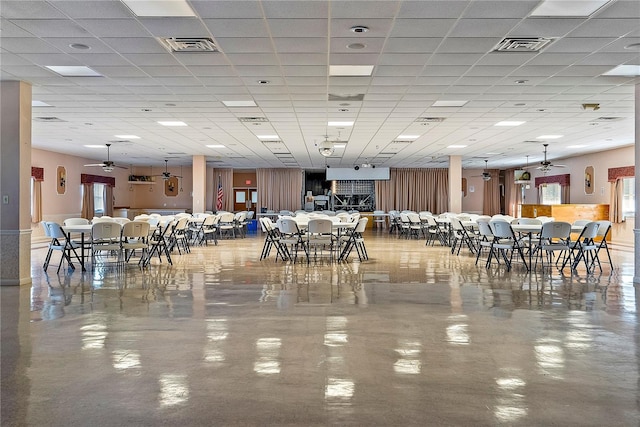 dining area with visible vents, a healthy amount of sunlight, ceiling fan, and a drop ceiling