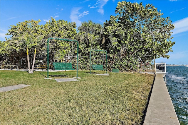 view of yard with playground community and fence