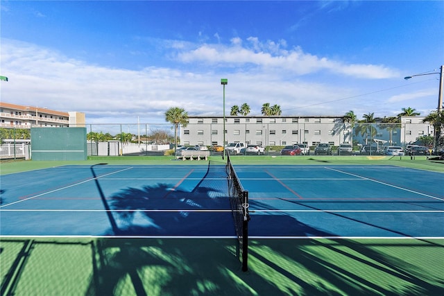 view of tennis court with fence