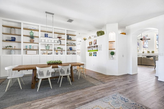 dining space with hardwood / wood-style flooring and ceiling fan