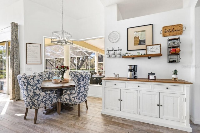 dining area with a high ceiling and hardwood / wood-style flooring