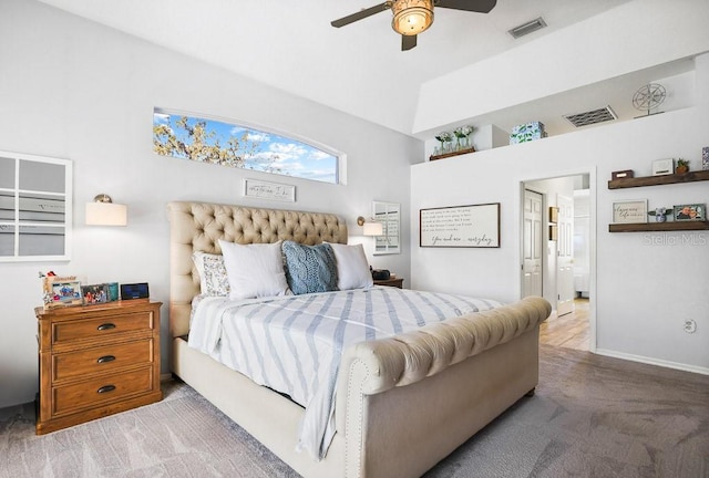 carpeted bedroom with ensuite bath and ceiling fan