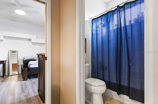 bathroom featuring ceiling fan, wood-type flooring, and toilet