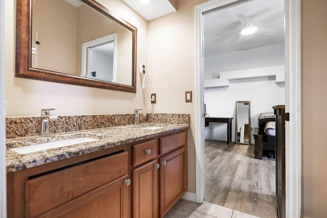 bathroom with ceiling fan, vanity, and hardwood / wood-style flooring