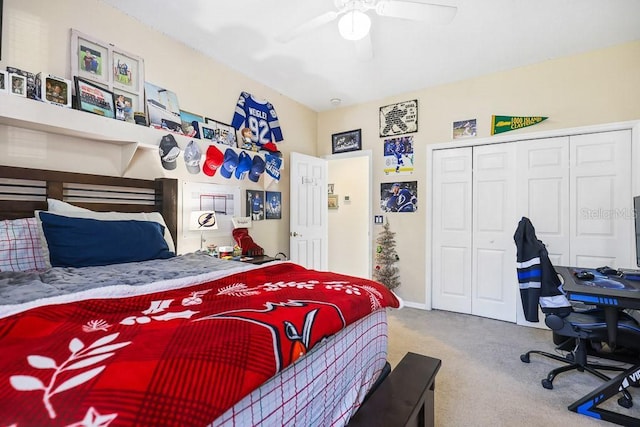 carpeted bedroom with ceiling fan and a closet