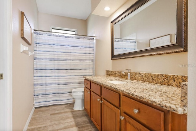 bathroom with hardwood / wood-style floors, vanity, toilet, and a shower with curtain