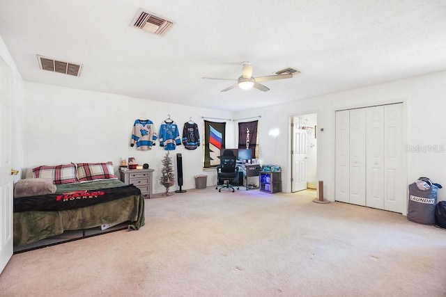 carpeted bedroom featuring a closet and ceiling fan