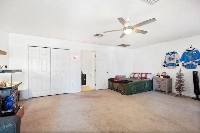 bedroom with ceiling fan, light carpet, and a closet