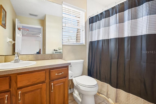 bathroom with tile patterned flooring, vanity, and toilet