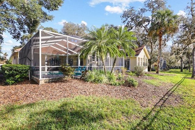 view of yard featuring glass enclosure and a swimming pool