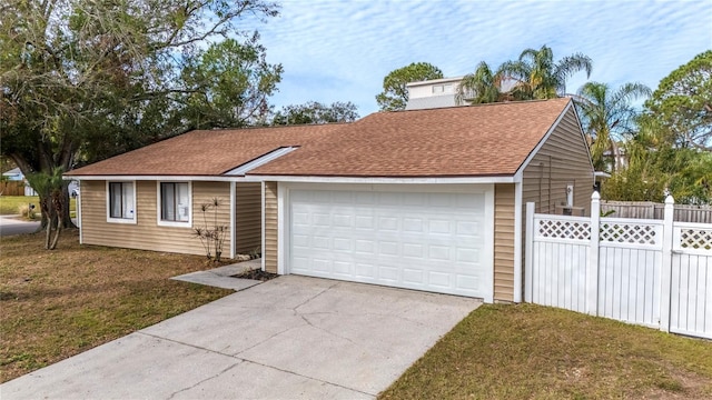 single story home with a front yard and a garage