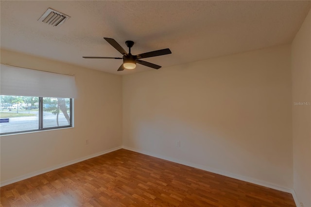 spare room with hardwood / wood-style floors and ceiling fan