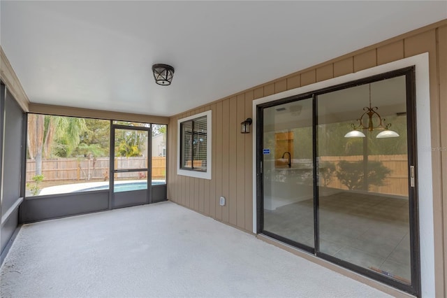 unfurnished sunroom with a chandelier