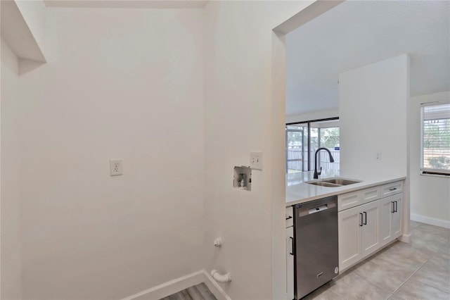 102 Shoreview Ln, Oldsmar, FL 34677 - kitchen with dishwasher, a sink, baseboards, white cabinets, and light countertops
