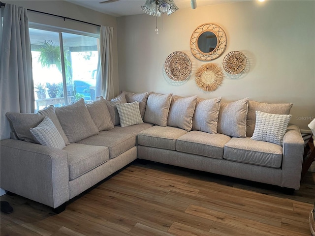 living room featuring hardwood / wood-style floors and ceiling fan