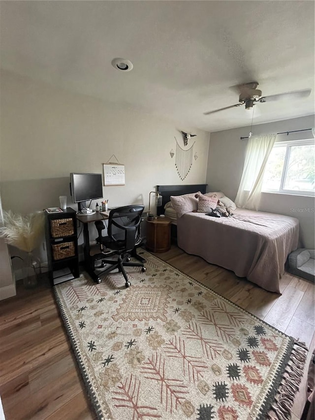 bedroom featuring wood-type flooring and ceiling fan