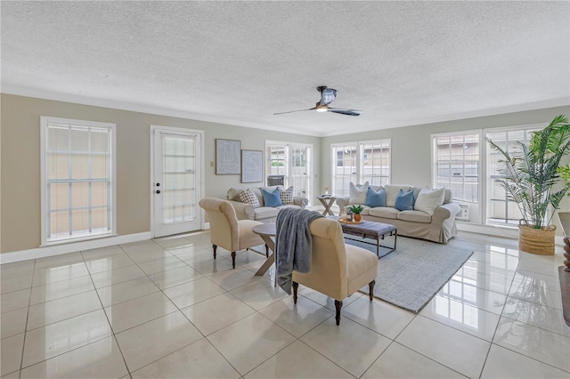 living room featuring ceiling fan, crown molding, light tile patterned floors, and a textured ceiling